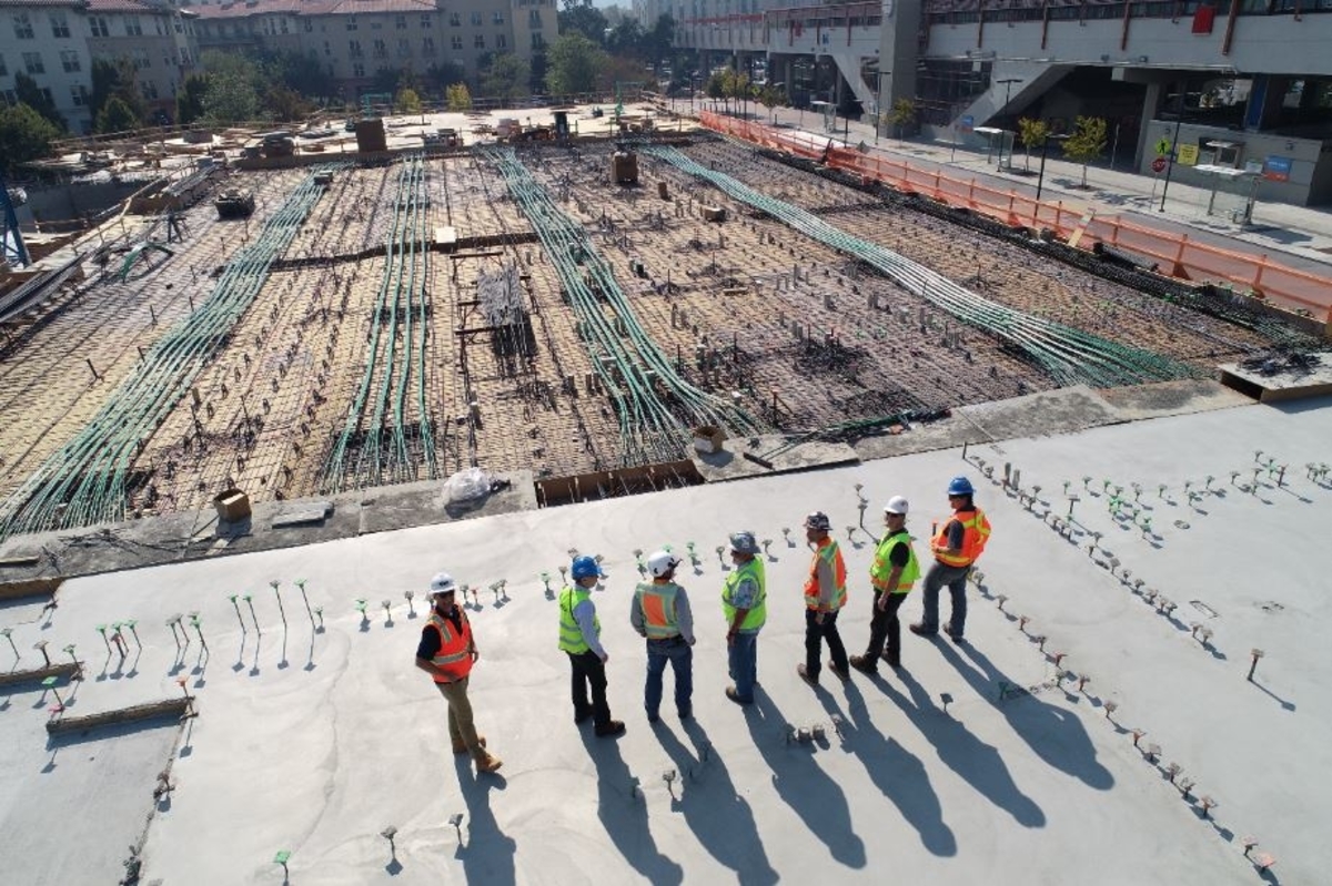 Construction workers standing on foundation